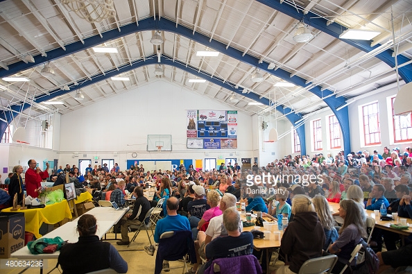 480634236-runners-crew-volunteers-and-staff-sit-in-the-gettyimages